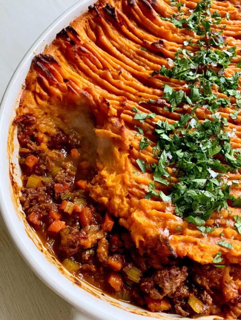 Close up of fork-crimped charred sweet potato peaks on a Paleo sweet potato shepherd's pie.